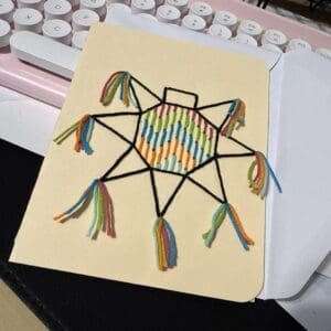 Mexican piñata embroidery card handmade with colorful stitches, inspired by traditional Mexican celebration and joy.